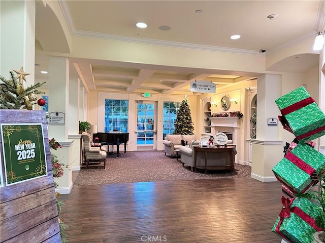 living room featuring dark hardwood / wood-style flooring, beam ceiling, coffered ceiling, and crown molding