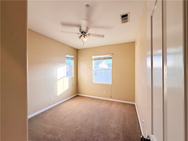 unfurnished room with carpet and ceiling fan