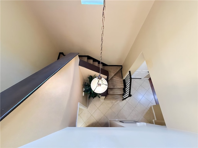 stairway featuring tile patterned flooring