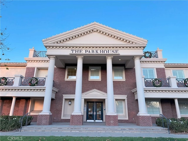 neoclassical / greek revival house featuring a balcony