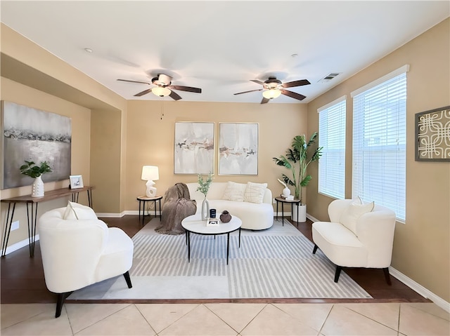 tiled living room with ceiling fan