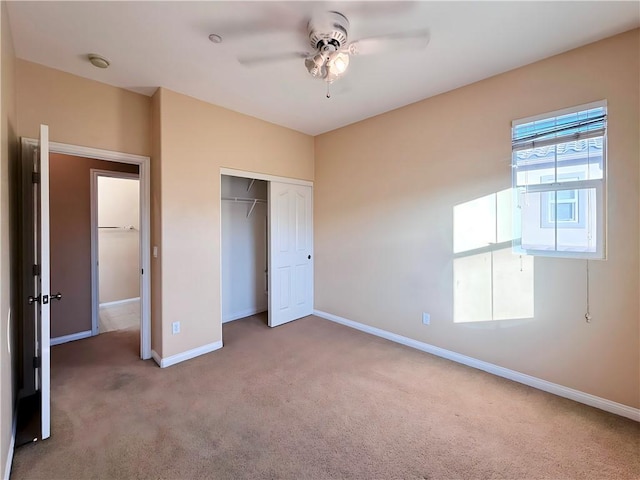 unfurnished bedroom with ceiling fan, a closet, and carpet