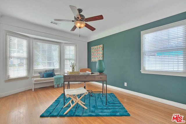 office space featuring ceiling fan, a healthy amount of sunlight, and hardwood / wood-style floors