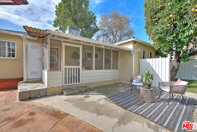 exterior space with a sunroom and a patio area