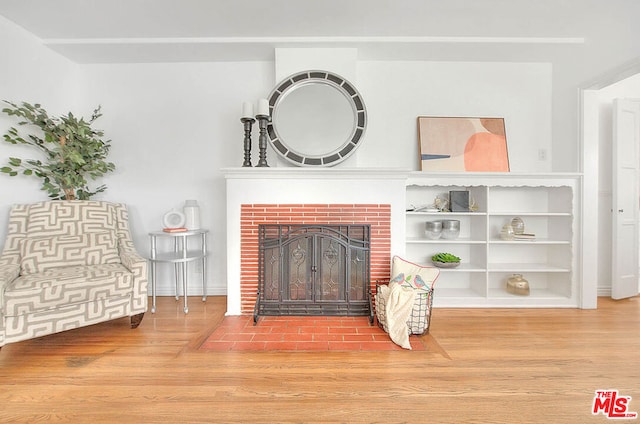 interior space featuring a brick fireplace and hardwood / wood-style floors