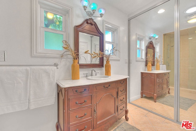 bathroom with vanity, tile patterned flooring, and a shower with shower door