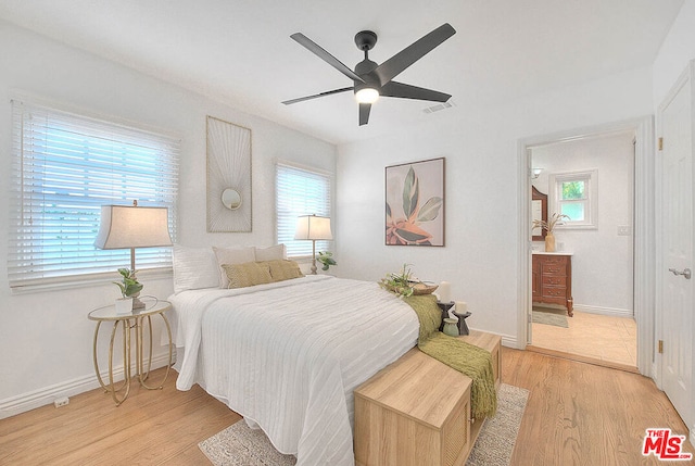 bedroom with ceiling fan, multiple windows, and light hardwood / wood-style flooring