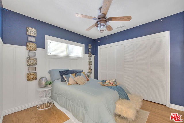 bedroom featuring a closet, ceiling fan, and light wood-type flooring