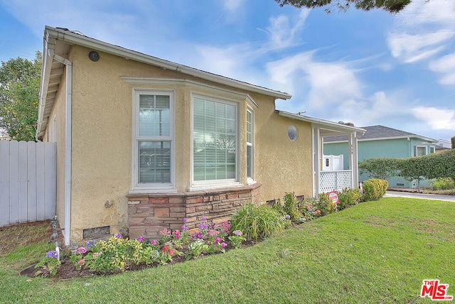 view of home's exterior with a lawn