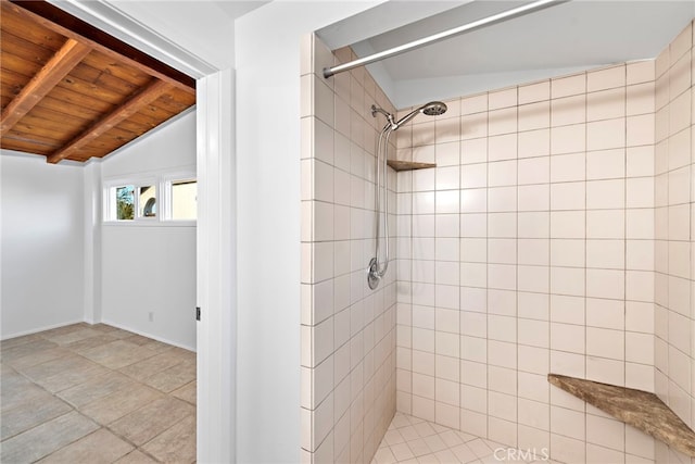 bathroom with vaulted ceiling with beams, wood ceiling, and a tile shower