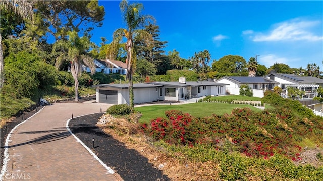 single story home with a garage and a front yard