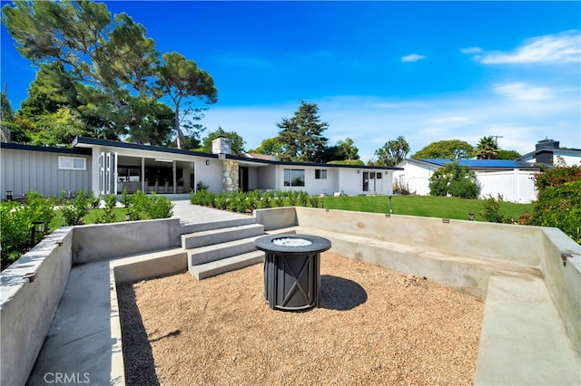 rear view of house with a fire pit