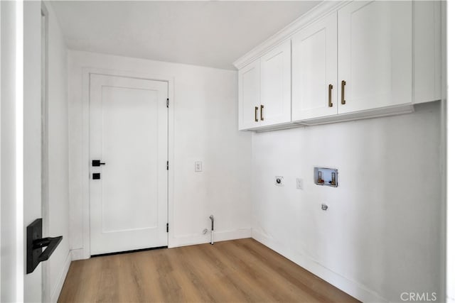 washroom with hookup for a gas dryer, cabinets, hookup for a washing machine, hookup for an electric dryer, and light wood-type flooring