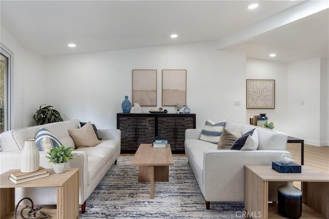 living room with hardwood / wood-style flooring and beamed ceiling