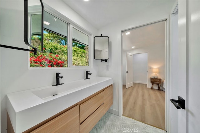 bathroom with vanity and hardwood / wood-style flooring