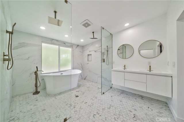 bathroom with vanity and separate shower and tub