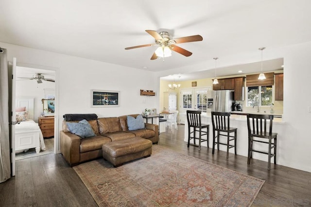 living room with ceiling fan and dark hardwood / wood-style floors