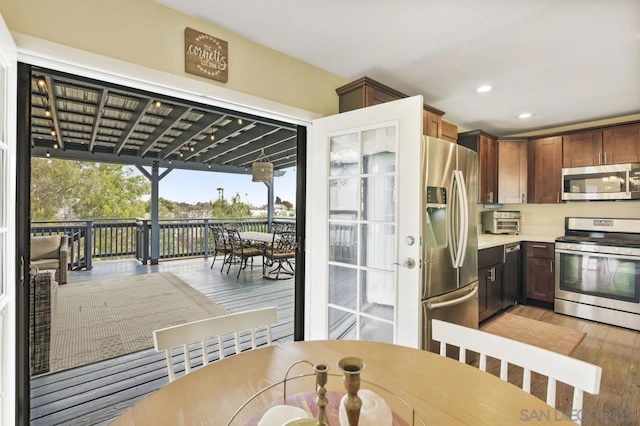 kitchen with stainless steel appliances and light hardwood / wood-style floors