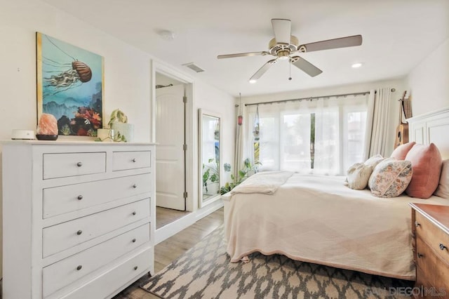 bedroom with ceiling fan and light hardwood / wood-style floors