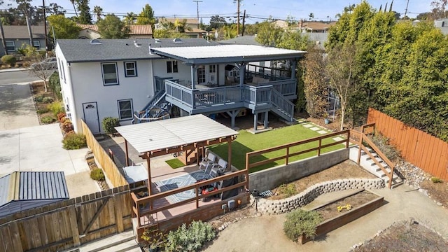 rear view of house with a yard and a deck