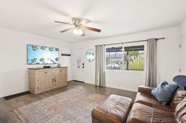 living room featuring dark hardwood / wood-style floors and ceiling fan