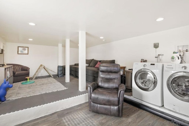 laundry room with washer and dryer and dark wood-type flooring