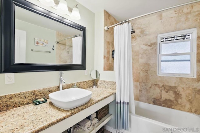 bathroom featuring vanity and shower / tub combo with curtain