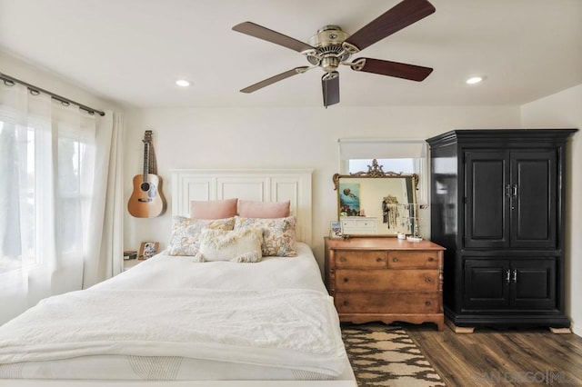 bedroom with dark hardwood / wood-style floors and ceiling fan