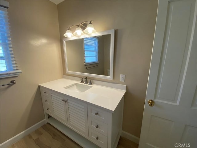 bathroom with hardwood / wood-style flooring and vanity