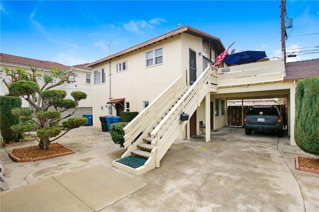 back of property featuring a carport