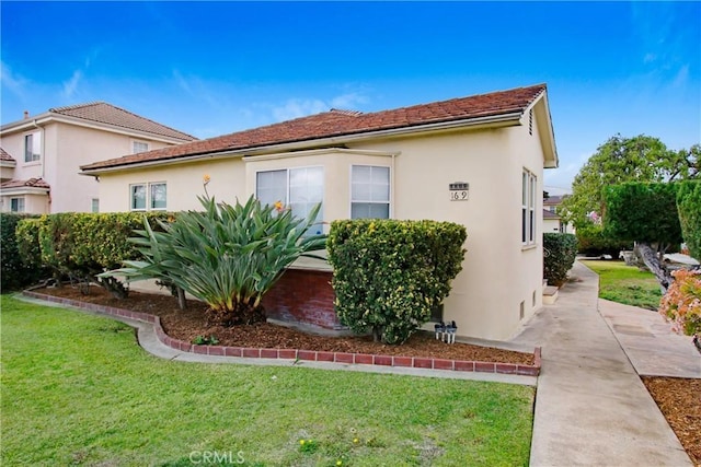 1605 S Atlantic Blvd, Alhambra, CA 91803 - view of side of home featuring a lawn and stucco siding
