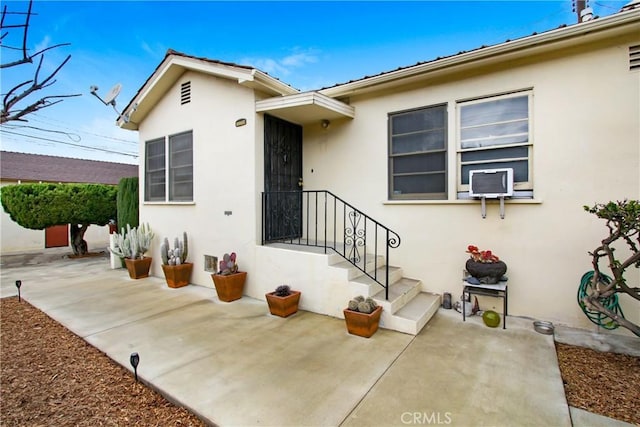 property entrance featuring a patio area