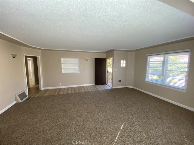 1605 S Atlantic Blvd, Alhambra, CA 91803 - unfurnished living room with a textured ceiling, carpet flooring, and baseboards