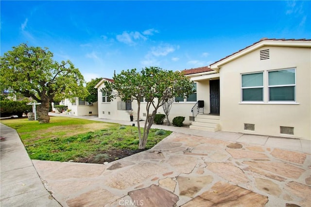 1605 S Atlantic Blvd, Alhambra, CA 91803 - view of front of property with stucco siding, a tile roof, and a front yard