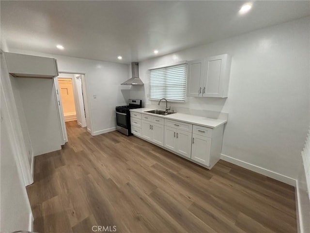 1605 S Atlantic Blvd, Alhambra, CA 91803 - kitchen featuring stainless steel gas range, a sink, wall chimney range hood, baseboards, and recessed lighting