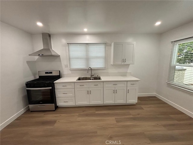 1605 S Atlantic Blvd, Alhambra, CA 91803 - kitchen featuring wall chimney exhaust hood, stainless steel range with gas stovetop, a sink, white cabinetry, and recessed lighting