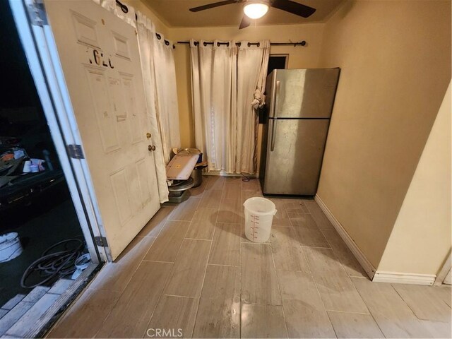 interior space featuring ceiling fan and stainless steel fridge