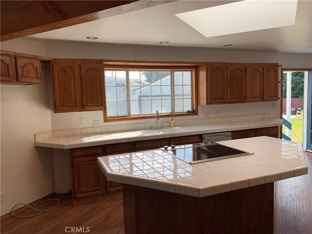 kitchen featuring tile countertops, dishwasher, sink, black electric stovetop, and dark wood-type flooring