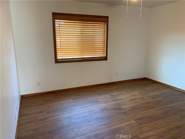 empty room with dark hardwood / wood-style flooring