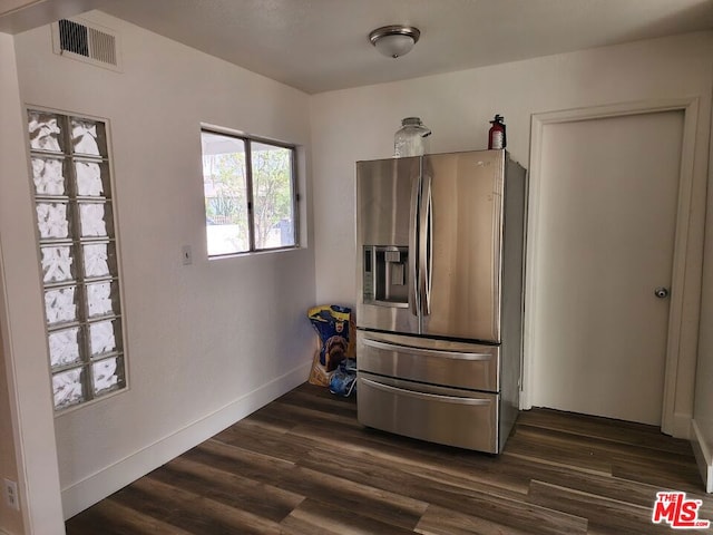 kitchen with dark hardwood / wood-style floors and stainless steel fridge