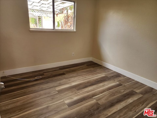 empty room with dark wood-type flooring