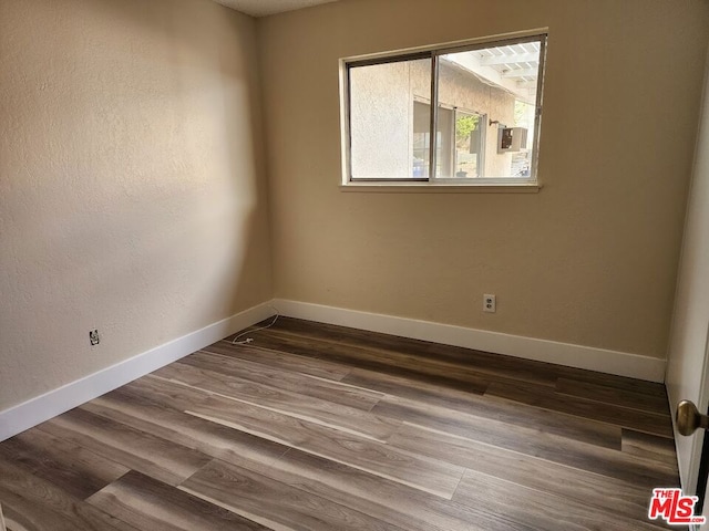 spare room with hardwood / wood-style floors