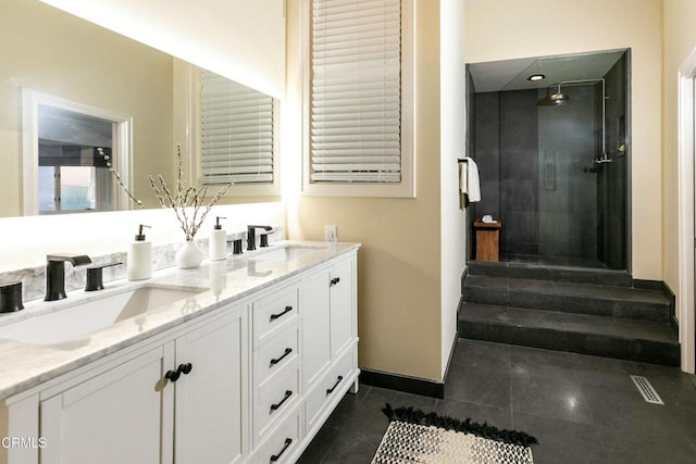 full bath with double vanity, visible vents, a stall shower, and a sink