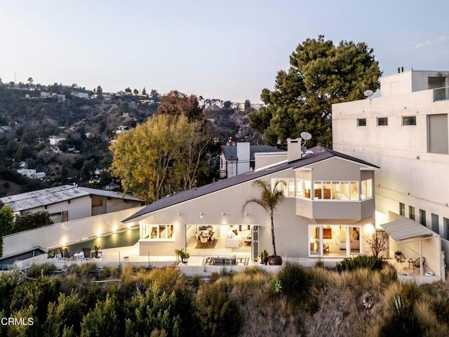 8326 Grand View Dr, Los Angeles, CA 90046 - back of property with stucco siding and a chimney