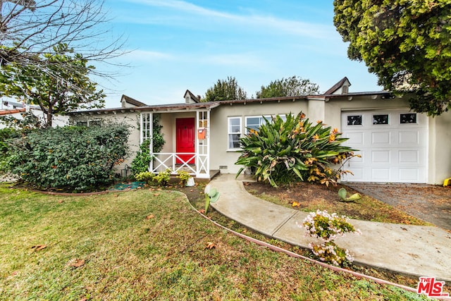 ranch-style home featuring a garage and a front lawn