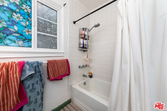 bathroom with shower / bath combo with shower curtain