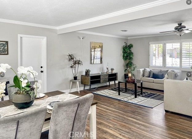 living room with crown molding, dark hardwood / wood-style floors, and ceiling fan