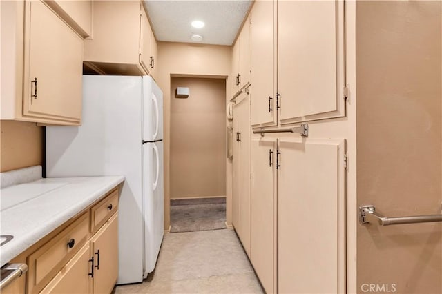 332 E 7th St, San Jacinto, CA 92583 - kitchen featuring white refrigerator and cream cabinets