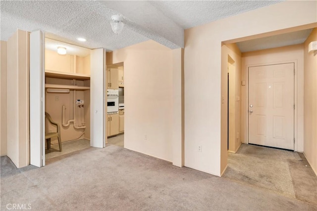 332 E 7th St, San Jacinto, CA 92583 - interior space featuring light carpet and a textured ceiling