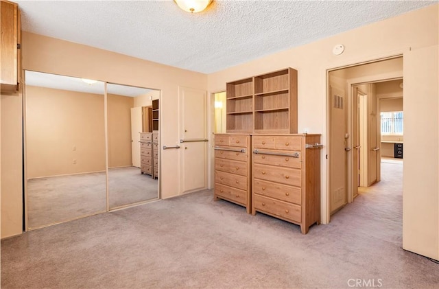 332 E 7th St, San Jacinto, CA 92583 - bedroom featuring light colored carpet, a textured ceiling, and a closet
